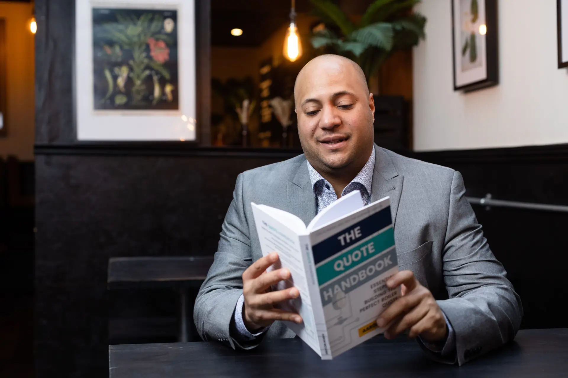 Aaron McLeish holding The Quote Handbook - author portrait